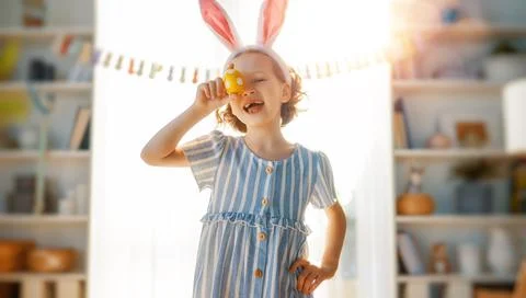 Child with Easter painting eggs Stock Photos
