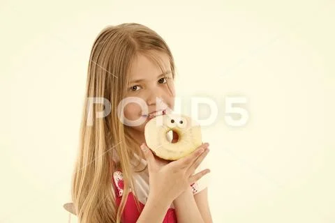 Child eat donut isolated on white. Little girl with glazed ring doughnut. Kid Stock Photos