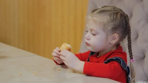 Child eating a bun Stock Footage 122435420