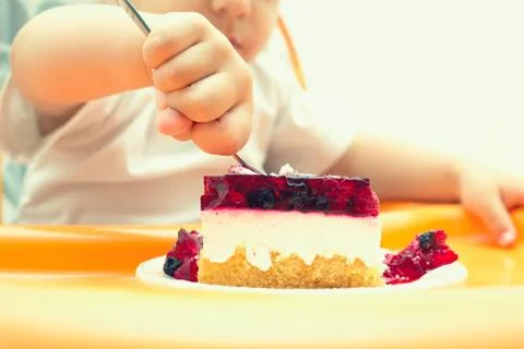 Child eating cake Stock Photos