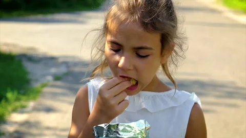 The child is eating chips. Selective focus. Stock Footage 167078470
