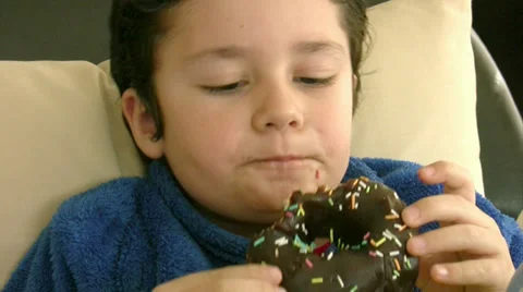 Child eating donut Stock Footage 35205396