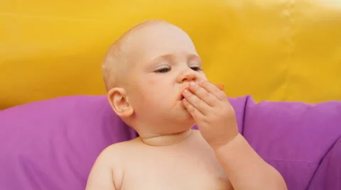 Child Eating Fruit Lying in an Easy Chair Stock Footage 64767152