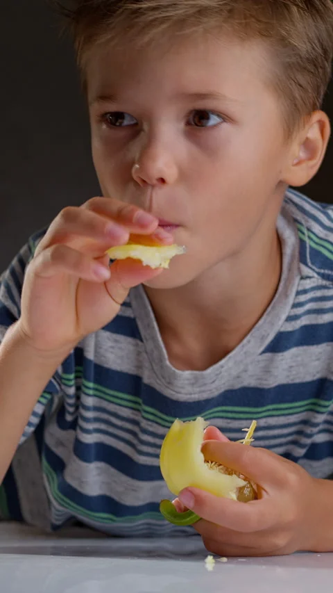 Child eating a pepper Stock Footage 315521657