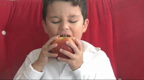Child eating red apple Stock Footage 32432791