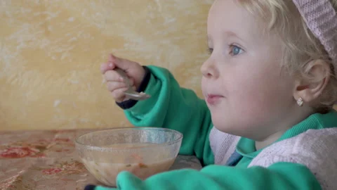 Child eating soup at the table Stock Footage 182467612