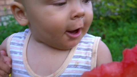 The child is eating a watermelon close-up 스톡 동영상 79983902