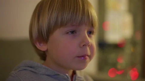 Child is eating while watching tv. shot in slow motion Stock Footage 146314602