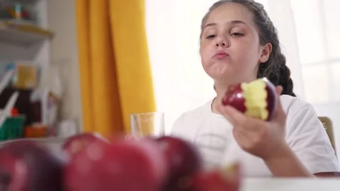 The child eats an apple and drinks juice. healthy eating fruit concept. child Stock Footage 289543335