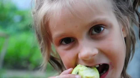 Child eats an apple outdoor Stock Footage 11297653
