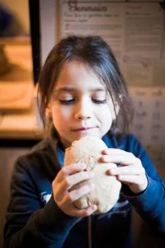Child eats big homemade bread Stock Photos