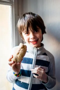 Child eats big homemade bread Stock Photos
