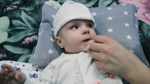 The child eats from a bottle. Spits out the milk and reaches for the bottle Stock Footage 102032082