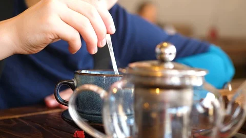 A child eats a bun with a cutlet and cheese in a fast food restaurant Видео 123356723
