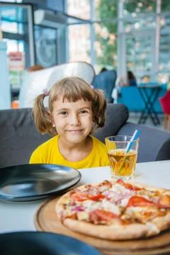 The child eats cheese pizza. Selective focus. Stock Photos