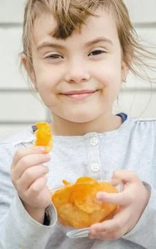 Child eats chips. selective focus. food and drink. Stock Photos