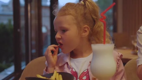 A child eats food, the process of a girl's meal 스톡 동영상 288531674