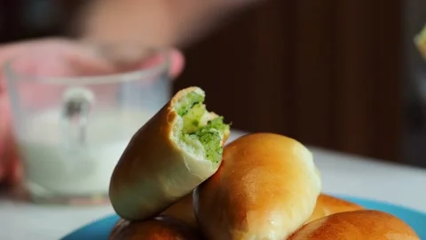 The child eats a freshly baked pie and drinks milk. Stock Footage 229762704