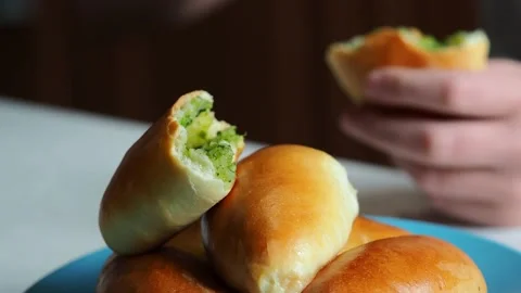The child eats a freshly baked pie and drinks milk. Stock Footage 229762718
