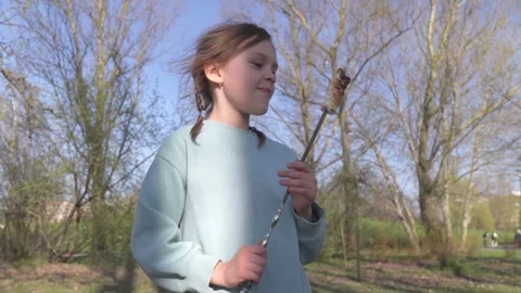 The child eats fried marshmallows, a fire. Outdoor recreation, active lifestyle Stock Footage 306762267