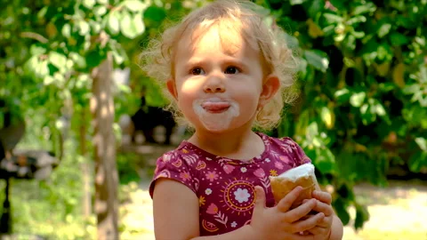 A child eats ice cream in the park. Selective focus. Stock Footage 218855340