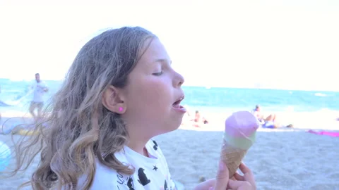 The child eats ice cream by the sea. Gelato in a cone Stock-Footage 231509948