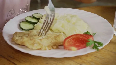 The child eats mashed potatoes with chop and fresh vegetables close-up Stock Footage 126291698