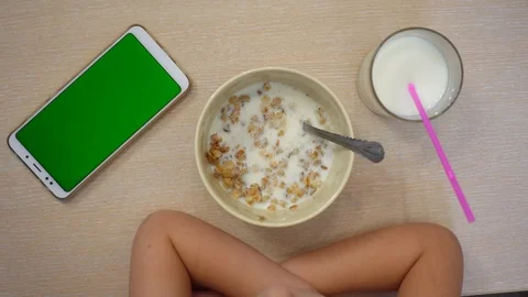 The child eats muesli with milk. Stock-Footage 96844179