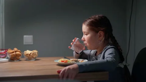 The child eats pasta with a fresh salad of tomato, pepper and round cheese. 4K Stock Footage 152418596