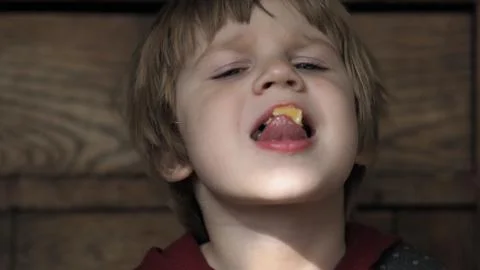 A child eats a piece of cheese Stock Photos