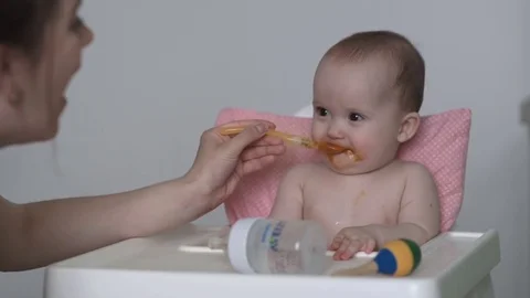 A child eats pumpkin puree Видео 75966146