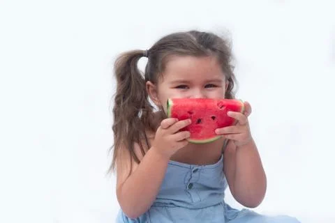 Child eats a red watermelon Stock Photos