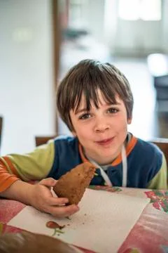 Child eats slice of cake at home Stock Photos