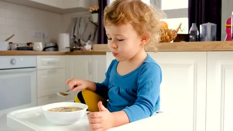 The child eats the soup from the plate. Selective focus. Stock Footage 234878706