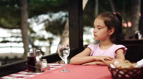 Child eats spaghetti pasta in the restaurant which is located on the shore Stock Footage 39829482
