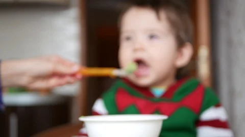 Child eats from a spoon. defocus video Stock Footage 127810830
