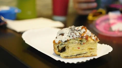 A child eats a sweet bun at the table. Close up shot Stock Footage 279064315