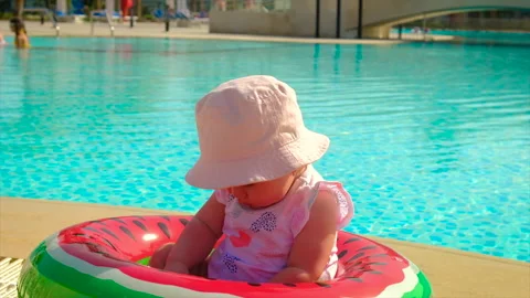 The child eats a watermelon near the pool. Selective focus. Stock Footage 156956074