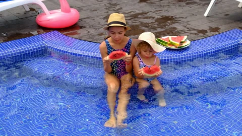 Child eats watermelon near the pool. Selective focus. Stock Footage 263909826