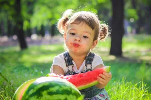 A child eats watermelon. Selective focus. Stock Photos
