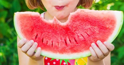 A child eats watermelon. Selective focus. Food. Stock Photos