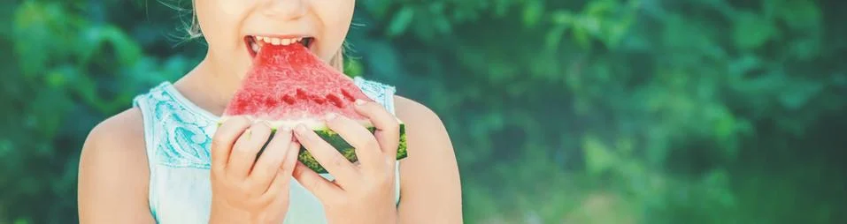 A child eats watermelon. Selective focus. food. Stock Photos