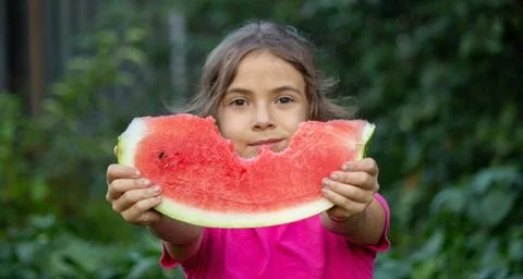 A child eats a watermelon. Selective focus. Stock Photos