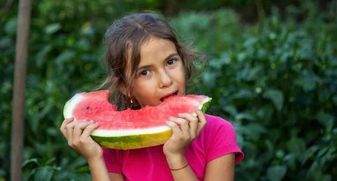 A child eats a watermelon. Selective focus. Stock Photos