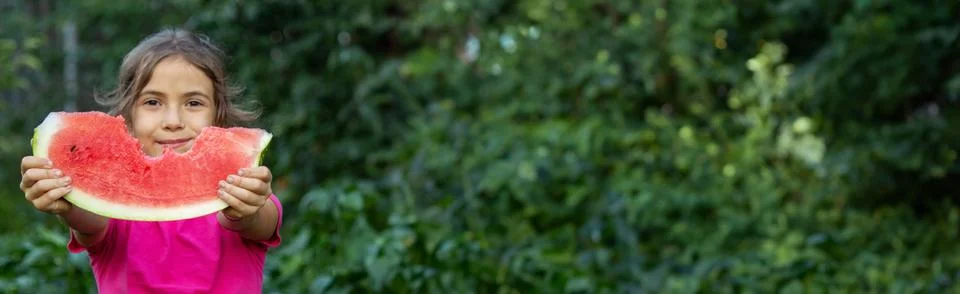 A child eats a watermelon. Selective focus. Stock Photos