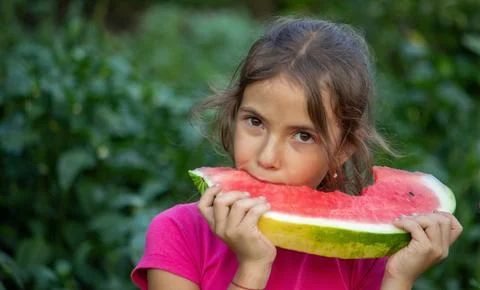 A child eats a watermelon. Selective focus. Stock Photos