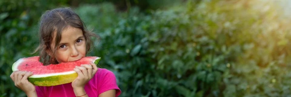 A child eats a watermelon. Selective focus. Stock Photos