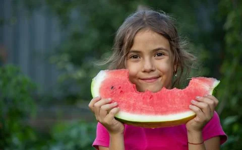 A child eats a watermelon. Selective focus. Stock Photos
