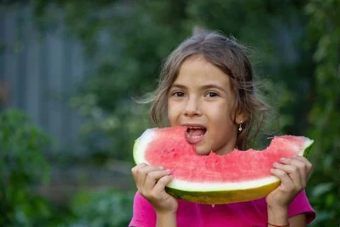 A child eats a watermelon. Selective focus. Stock Photos