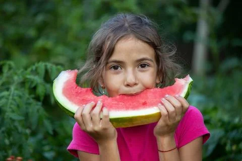 A child eats a watermelon. Selective focus. Stock Photos